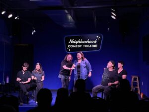 Improv students performing a Harold long-form scene on stage at the Neighborhood Comedy Theatre in downtown Mesa