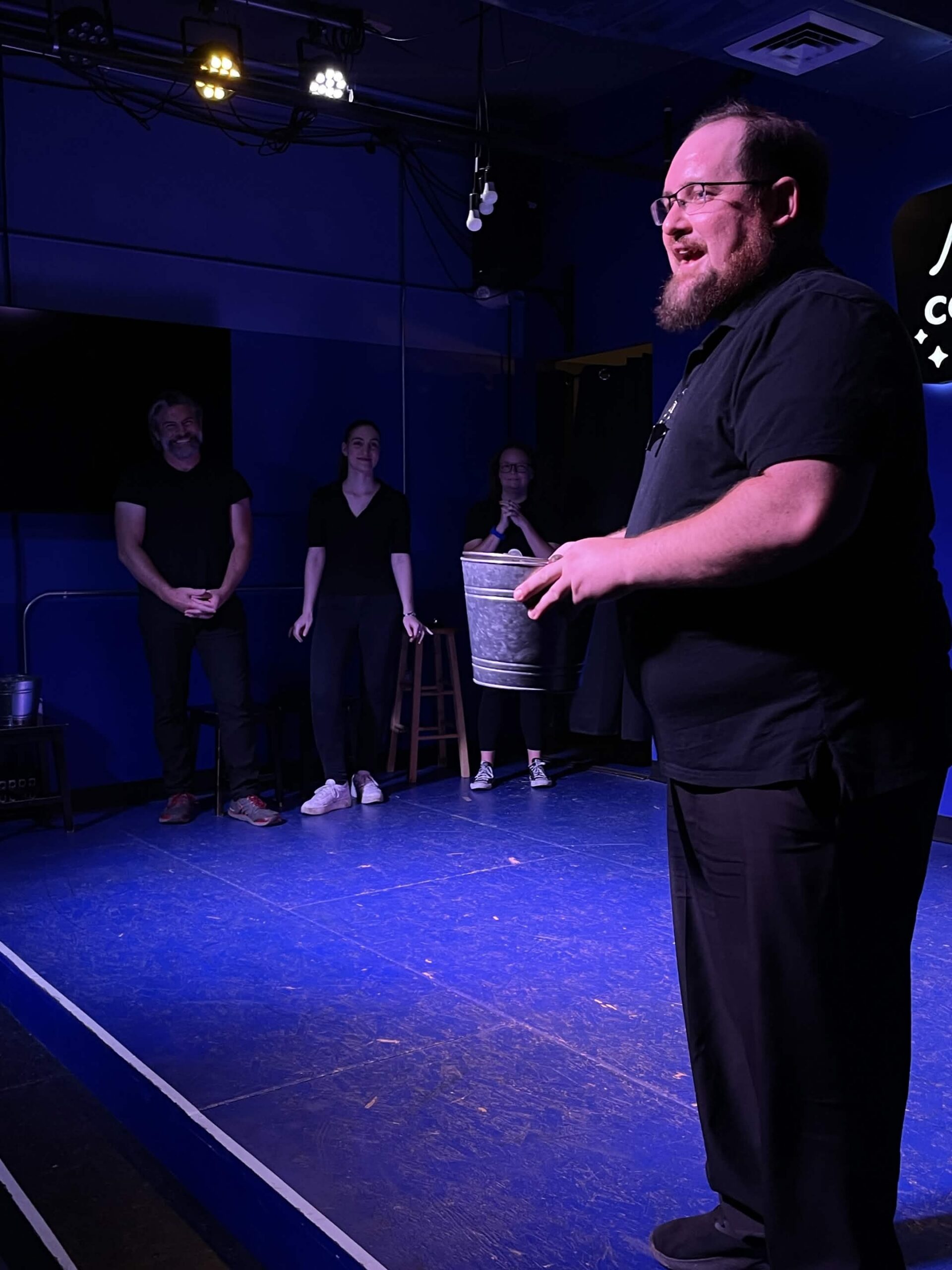 Improv students performing a Harold long-form scene on stage at the Neighborhood Comedy Theatre in downtown Mesa