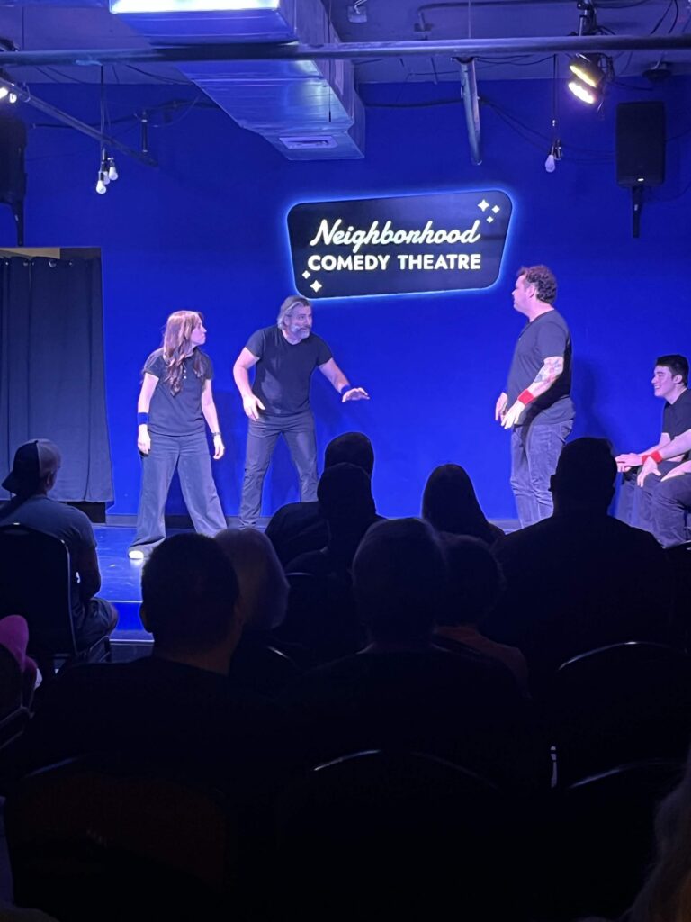 Improv students performing a Harold long-form scene on stage at the Neighborhood Comedy Theatre in downtown Mesa