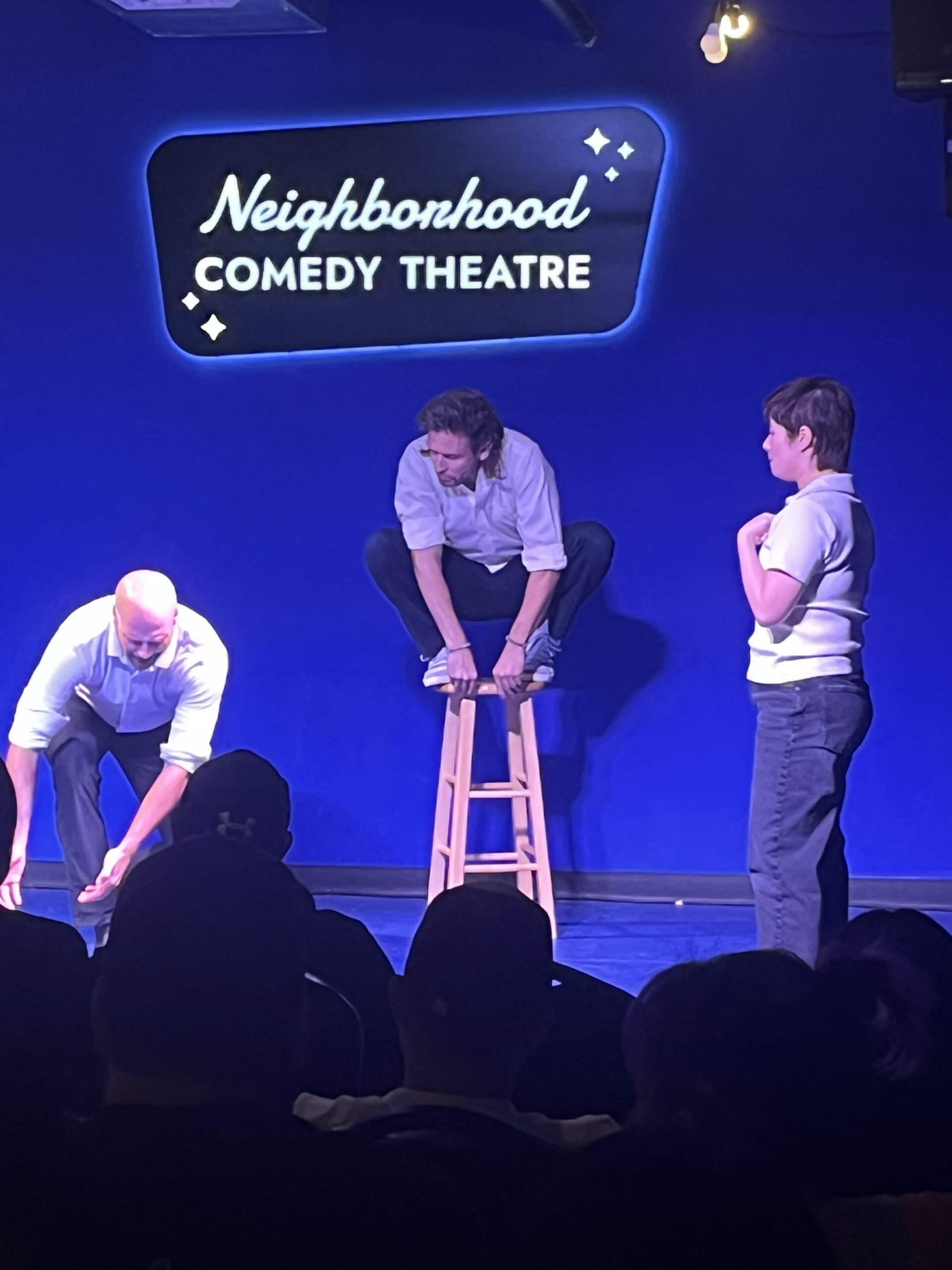 Improv students performing a Harold long-form scene on stage at the Neighborhood Comedy Theatre in downtown Mesa
