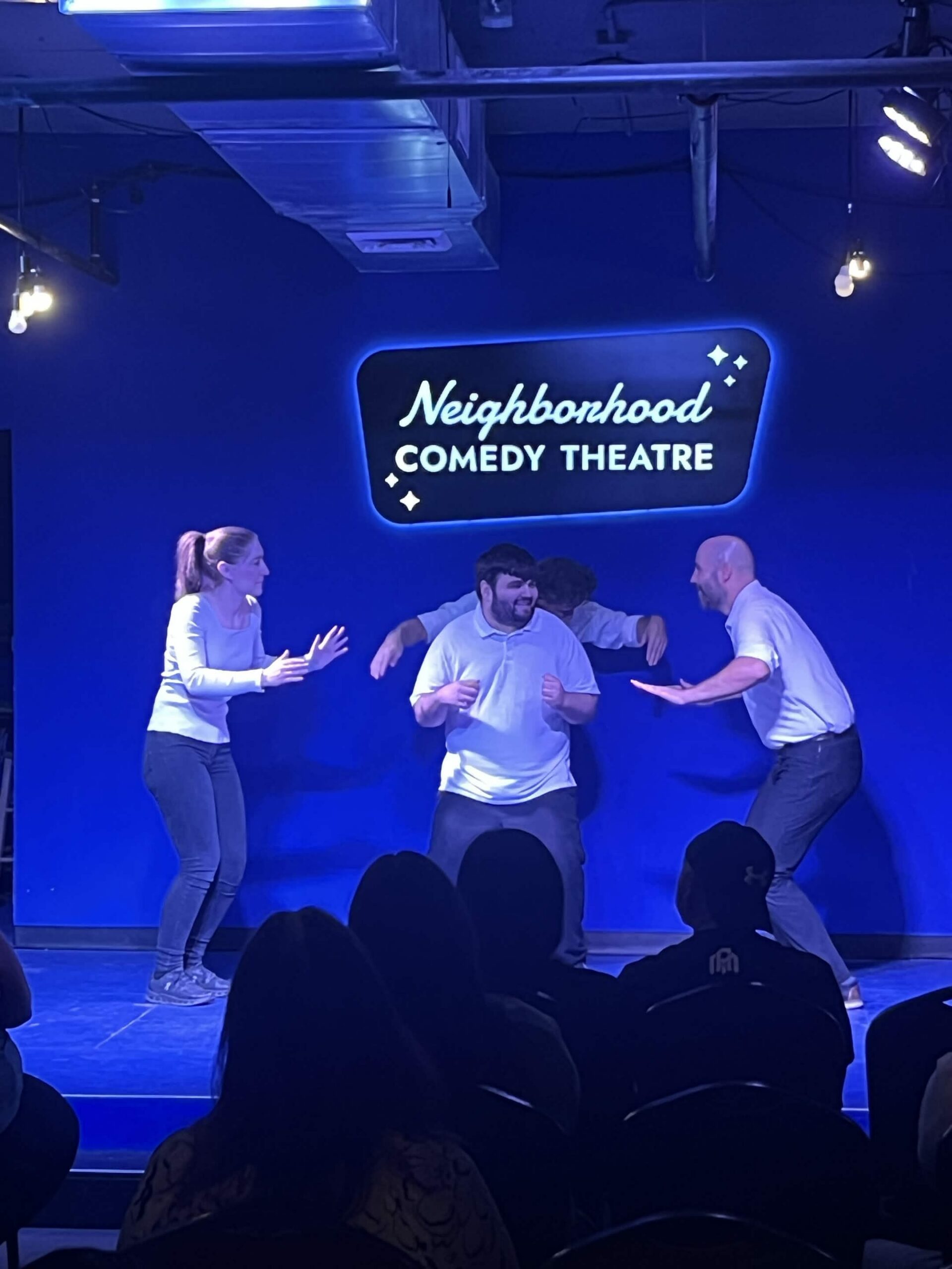 Improv students performing a Harold long-form scene on stage at the Neighborhood Comedy Theatre in downtown Mesa