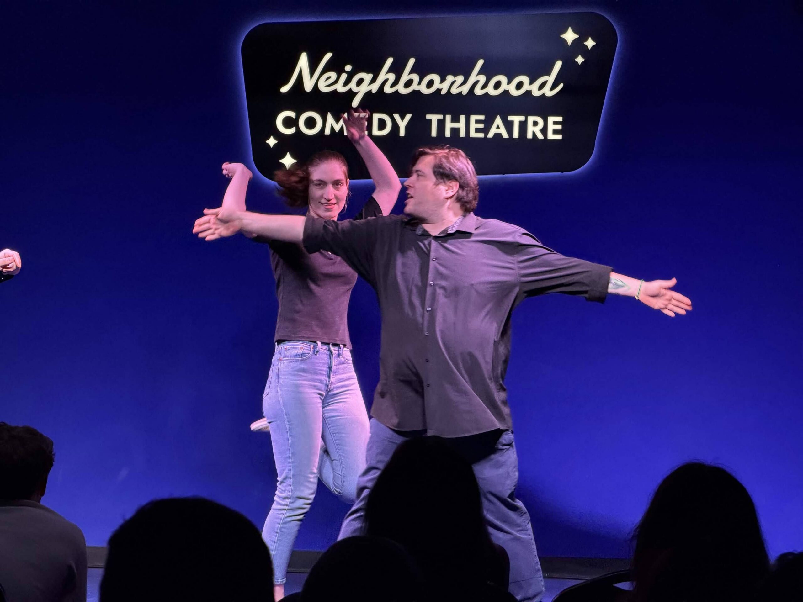 Improv students performing a Harold long-form scene on stage at the Neighborhood Comedy Theatre in downtown Mesa